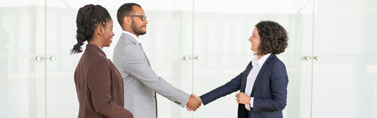 A-commercial-real-estate-investing-deal-is-celebrated-by-two-business-owners-and-a-lender-shaking-hands.
