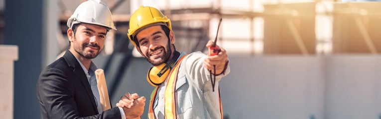 Business-owner-seeing-progress-of-his-commercial-construction-loan-project-and-shakes-hands-with-construction-worker.