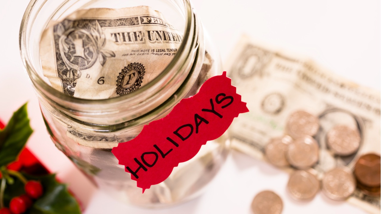 christmas-money-jar-with-coins-dollar-bills-saving-for-holidays-picture-id468423437
