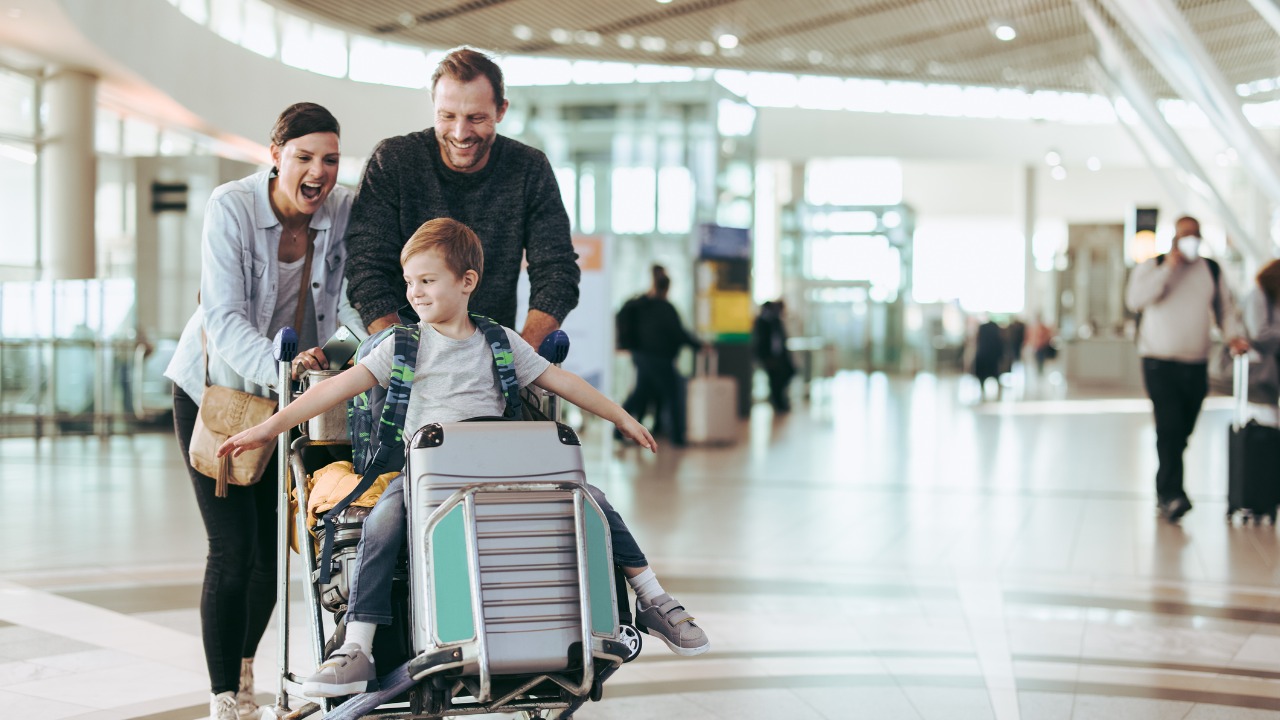 couple-pushing-trolley-with-their-child-at-airport.jpg_s=1024x1024&w=is&k=20&c=zINhrVnhIq7PrX7aqMyl7aAnsq1Y5YqVvWmvtR6XvN0=