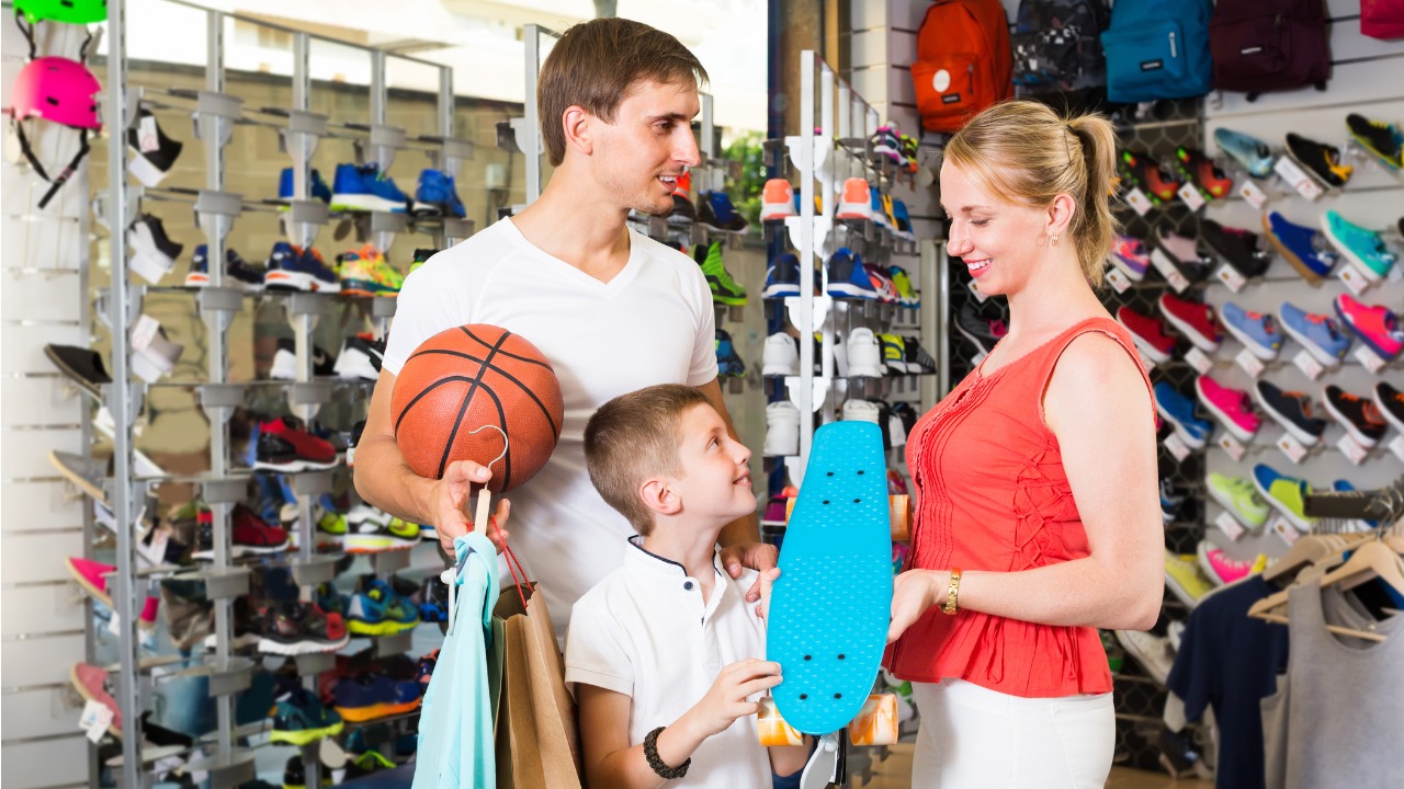 family-of-three-choosing-skateboard-in-store-picture-id845963064