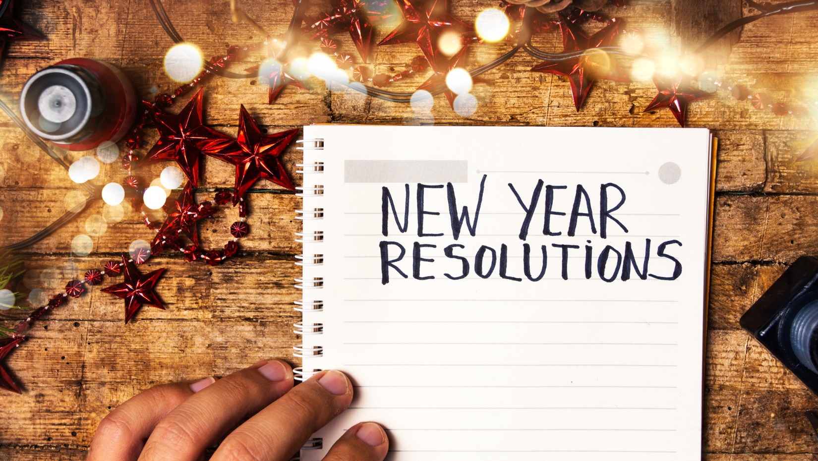 person-writing-new-year-resolutions-picture-id1076862558