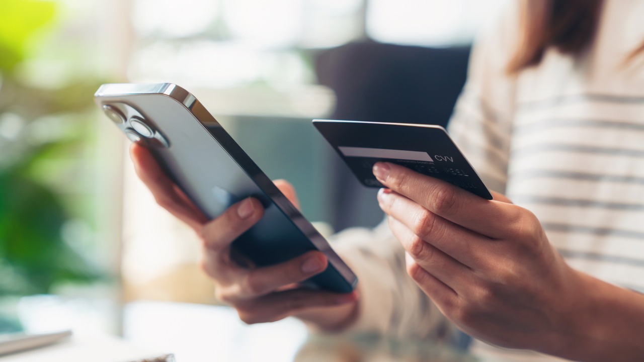 woman-hand-holding-credit-cards-and-using-smartphone-for-shopping-online-with-payment-on.jpg_s=1024x1024&w=is&k=20&c=1kUuvlFjRswFVgLEDkzCERxize0Fk8h3BWm322I-mt0=