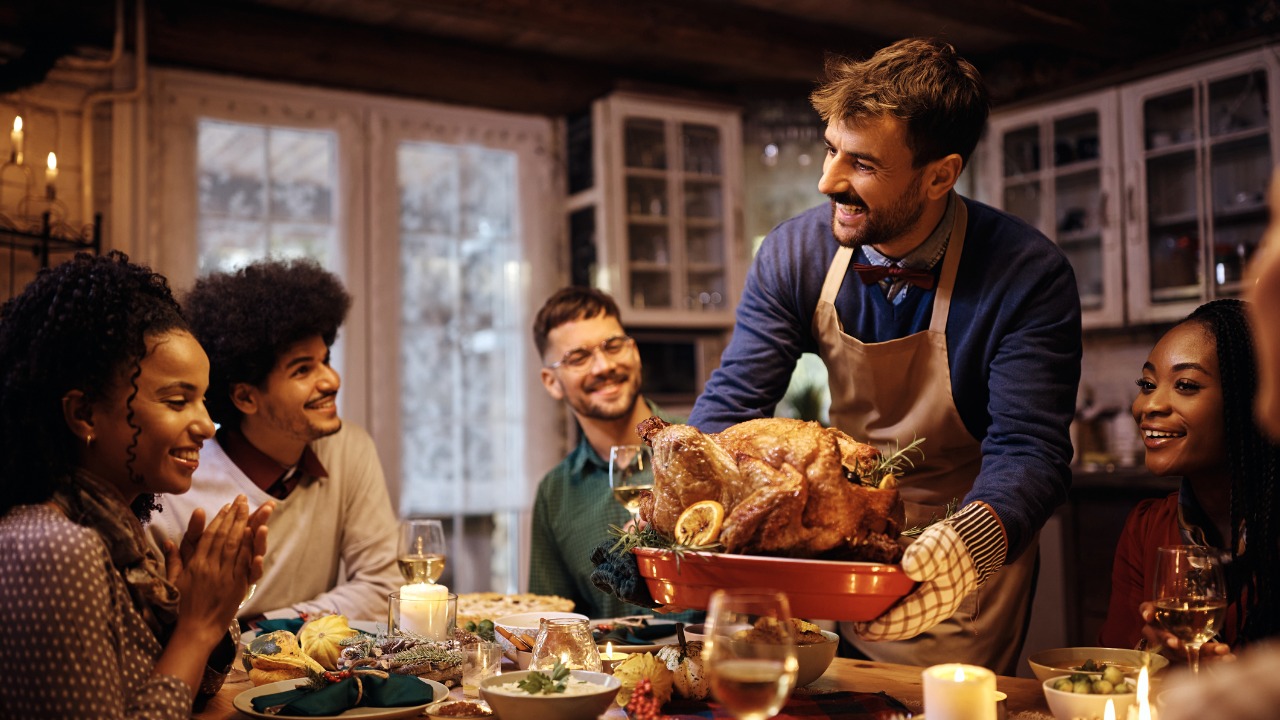 young-happy-man-serving-thanksgiving-turkey-to-his-friends-at-dining-table.jpg_s=1024x1024&w=is&k=20&c=_ze8weekMvPMe4fsB6gtC5YIOfJzYlOemQFUxLnmMz4=
